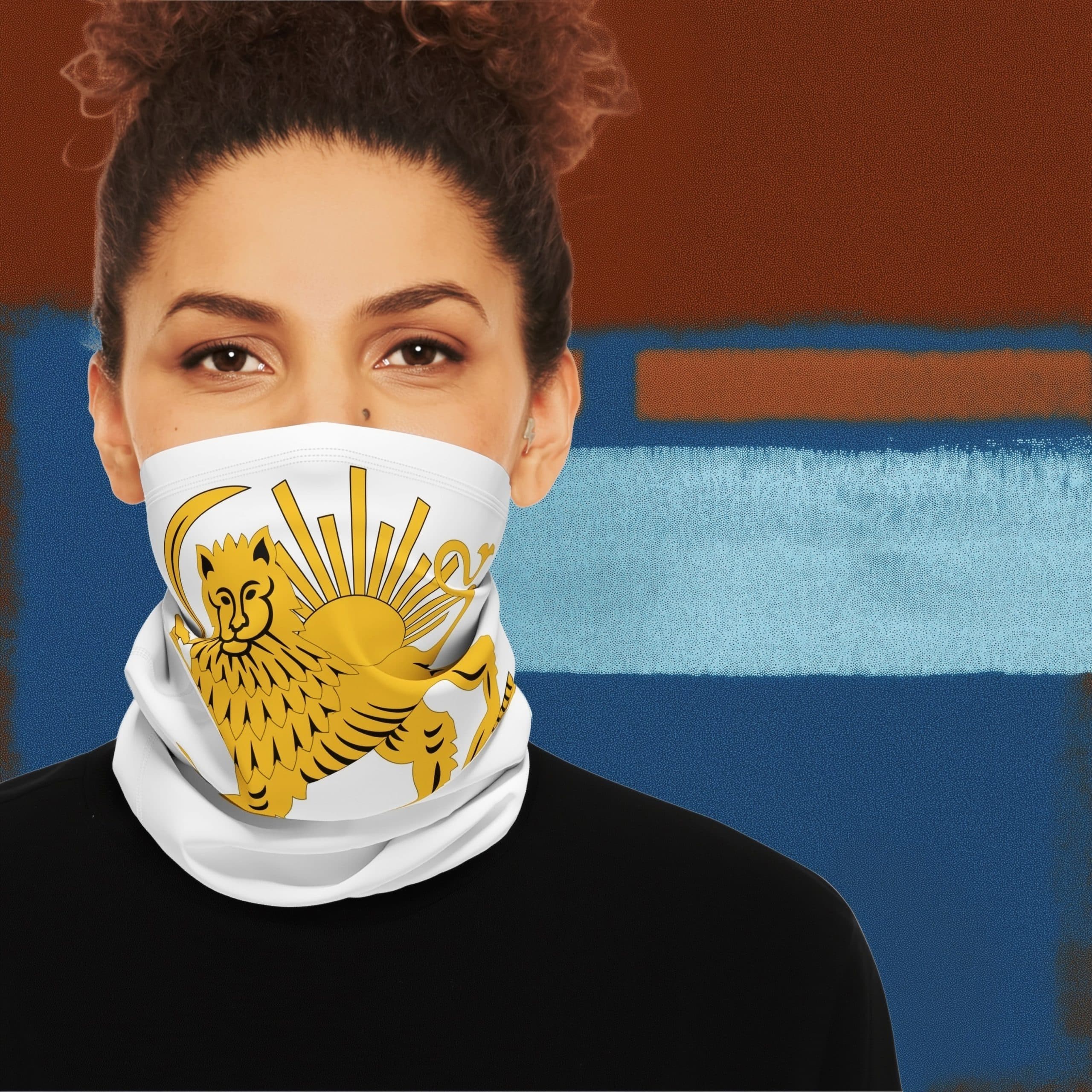 Front-facing woman wearing white Lion and Sun neck gaiter featuring gold Lion and Sun emblem against a blue and rust textured background.